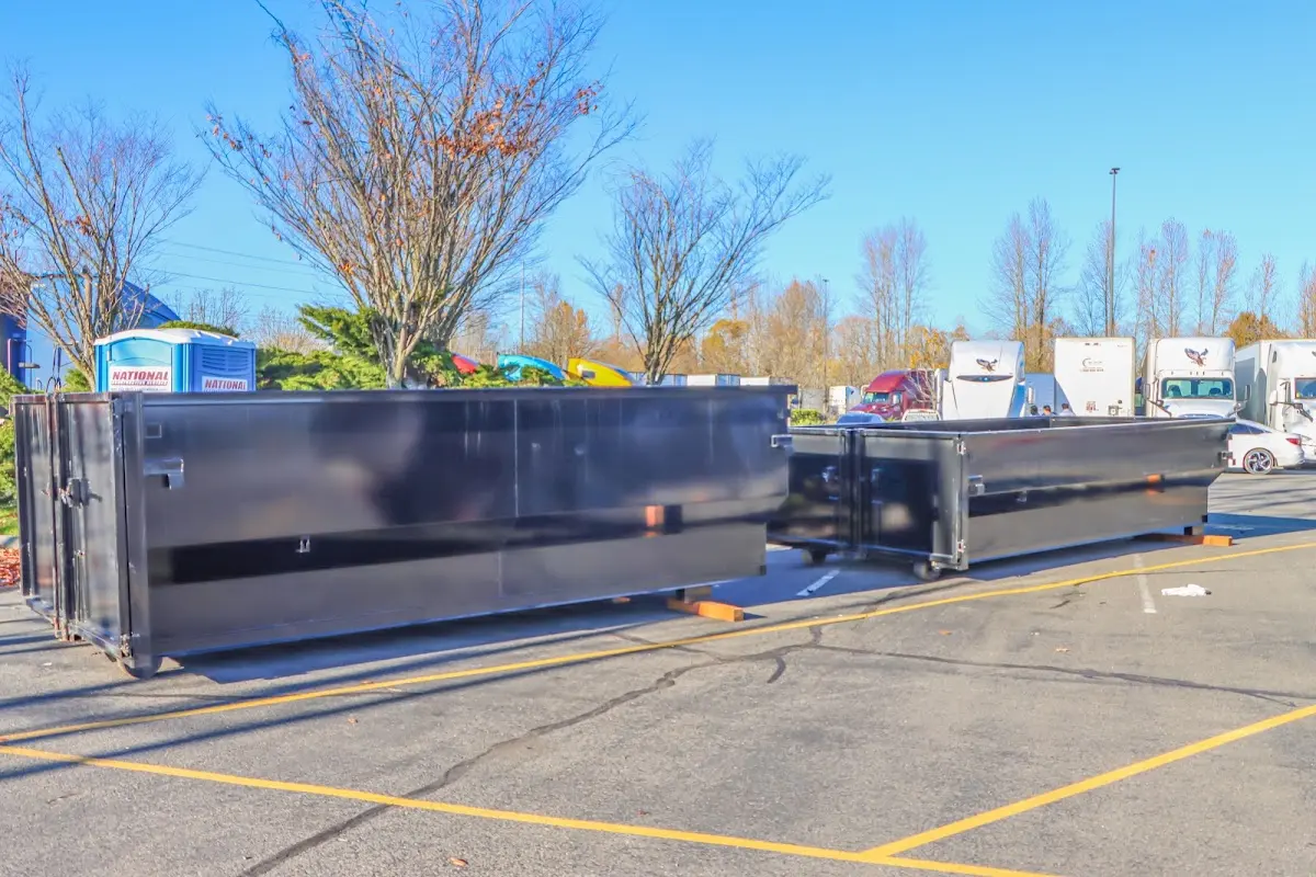 Professional dumpster rental service with roll-off container on residential driveway in Rocky Hill